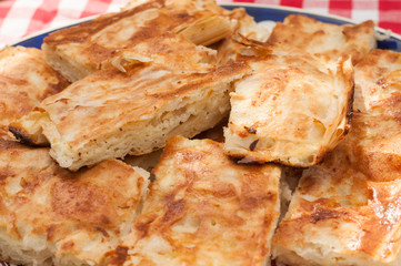 Pieces of traditional homemade filo pastry filled with white cheese