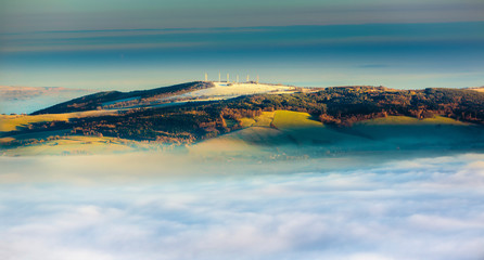 Sunrise and Inversion at Jested mountain close town Liberec, Czech republic, snow and winter and view of funicular, windmills.