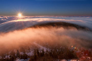 Fototapeta na wymiar Sunrise and Inversion at Jested mountain close town Liberec, Czech republic, snow and winter and view of funicular.