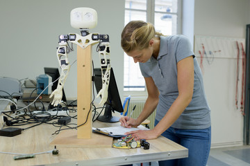 woman working small robotic arm working in the laboratory