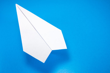 paper airplane made of white paper on a light blue background, copy space, mock up