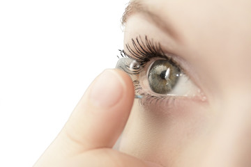 girl wearing soft contact lenses close-up macro isolated on white background.