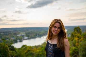 Fototapeta premium Portrait of young woman looking over a river