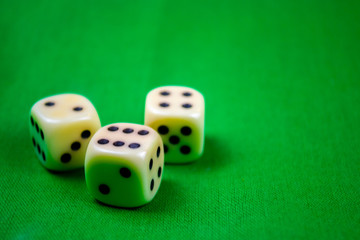 3 cubes dices on green background