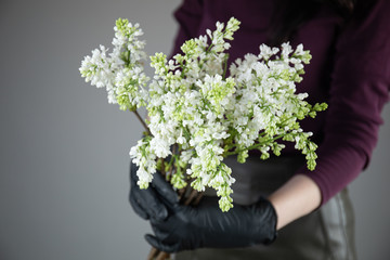 Beautiful bouquet of mixed flowers with peonies. The work of the florist. Flower delivery
