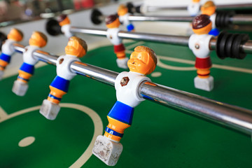 dolls of a retro foosball table to play table football