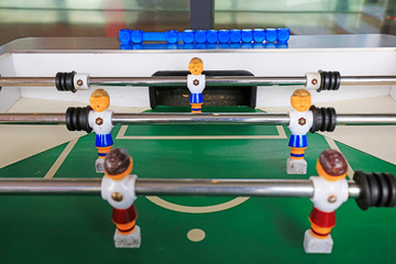 dolls of a retro foosball table to play table football
