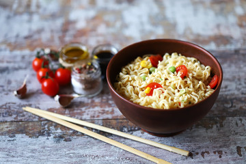 Chinese noodle bowl with spices. Food sticks. Selective focus.