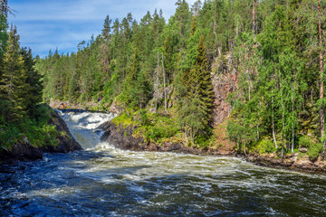 The flow of Yattumutka river and the waterfall at Jyrava view point in Oulanka National Park. Pieni Karhunkierros Trail in Finland.