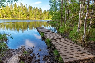 Wooden pontoon in the border of Yattumutka river in Oulanka National Park. Pieni Karhunkierros Trail in Finland.
