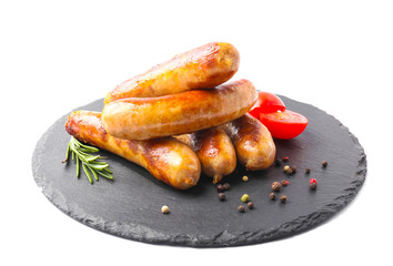 Slate plate with tasty grilled sausages on white background