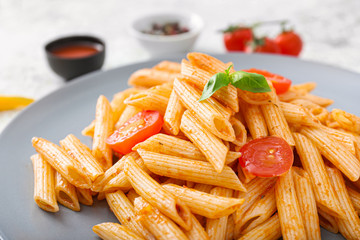Tasty pasta with tomato sauce on plate, closeup