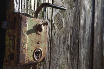 Old antique door handle on wooden door. Black and white photography