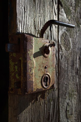 Old antique door handle on wooden door. Black and white photography