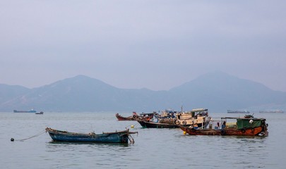 Sea and Mountains and Boats in Fog