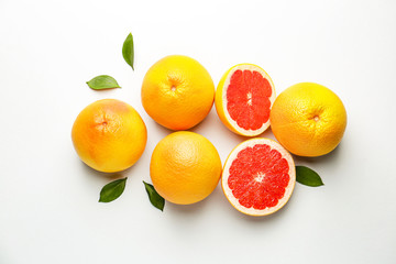 Fresh ripe grapefruits on light background
