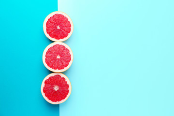 Fresh cut grapefruit on color background
