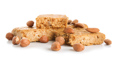 Tasty granola bars with nuts on white background