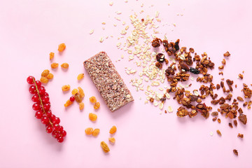 Tasty granola bar with ingredients on color background