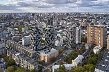 Fotobehang Luchtfoto op stadsgezicht met moderne hoogbouwwoningen © Andriy Bezuglov