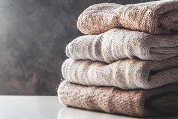 A stack of knitted sweaters ,the concept of warmth and comfort, hobby , background,closeup