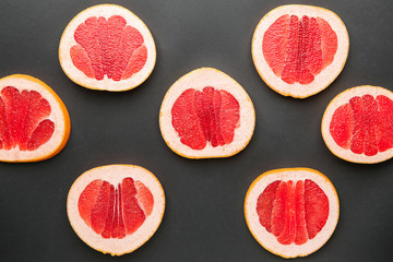 Fresh cut grapefruit on dark background