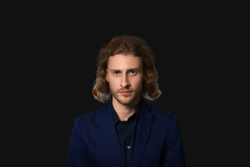 Portrait of handsome businessman on dark background