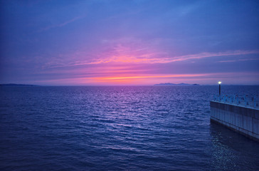 the horizon of a calm sea with a beautiful red sunset.