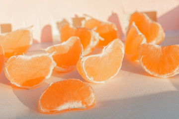 sliced ​​mandarin on a wooden stand with a white background