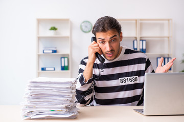 Young employee feeling like prisoner at work