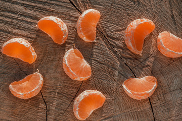 tangerine slices on a wooden background