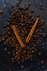 Roasted coffee beans and spice on a dark
