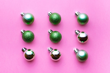 Christmas decoration balls isolated on pink background. Xmas pattern. Flat lay. Pattern winter bubble concept