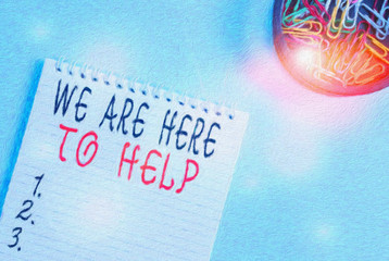 Writing note showing We Are Here To Help. Business concept for Someone who is always ready to Assist Support Give Blank empty notebook and stationary placed above pastel colour backdrop