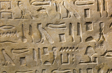 Ancient egypt hieroglyphs carved over sandstone, closeup