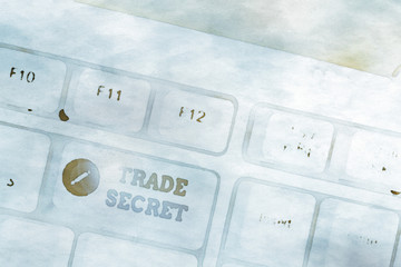Writing note showing Trade Secret. Business concept for technique used by a company in analysisufacturing its products White pc keyboard with note paper above the white background