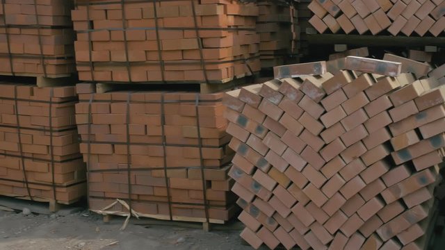 Forge workshop. Smithy manual production. Outdoor warehouse of bricks for laying furnaces. The blacksmith makes iron products for manufacture of fireplaces and stoves.