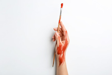 Artist's hand with brush on white background
