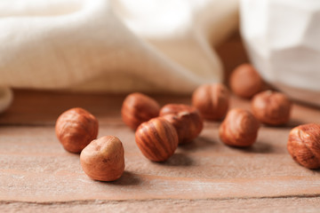 Tasty hazelnuts on wooden background