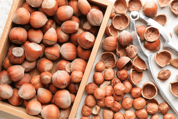 Many tasty hazelnuts on table