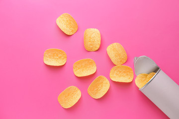 Pack of tasty potato chips on color background