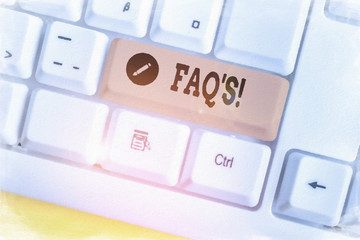 Text sign showing Faq. Business photo showcasing a list of questions and answers relating to a particular subject White pc keyboard with empty note paper above white background key copy space