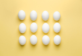 Fresh raw eggs on color background