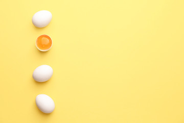 Fresh raw eggs on color background