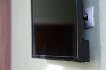 An example of installing a TV or monitor on a wall. How to hide wires and an electrical outlet