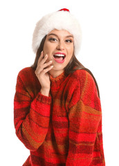 Beautiful young woman in Santa hat on white background