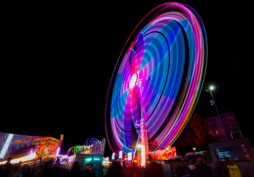 Ferris wheel in motion in the amusement park, at night. Long exposure photography. © Aron M - Austria