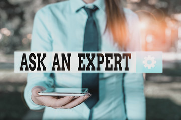 Conceptual hand writing showing Ask An Expert. Concept meaning consult someone who has skill about something or knowledgeable Business woman in shirt holding laptop and mobile phone