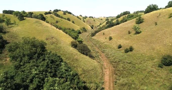 Hilly landscape strange green hills aerial drone shot.mp4