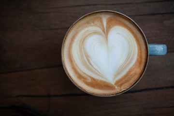 Cappuccino serving on wooden background
